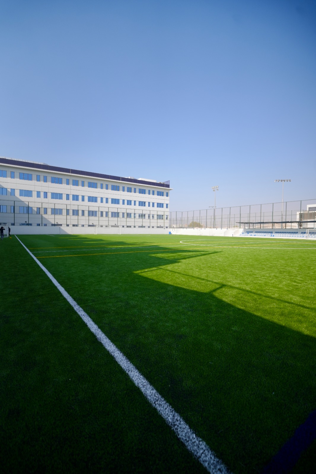 New artificial grass football pitch with white and yellow field markings